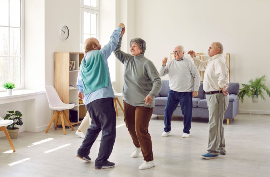 A group of older adults stay physically active by dancing together.